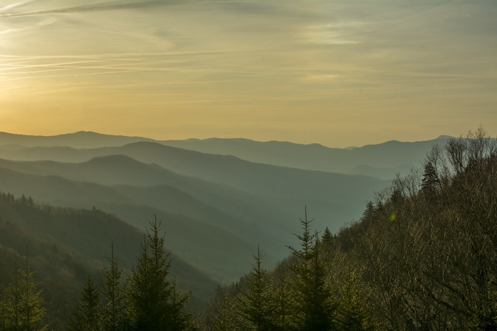 Rolling mountains against yellow susnet