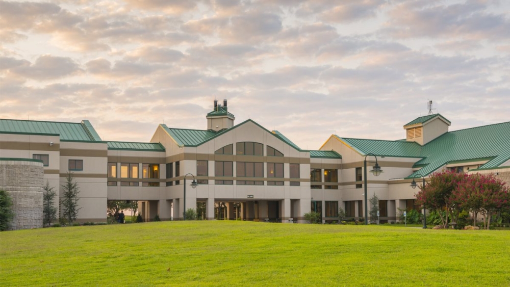 A large building at sunset with many windows