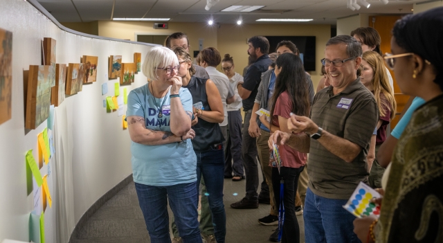 A group of course participants discuss responses to a group work question.